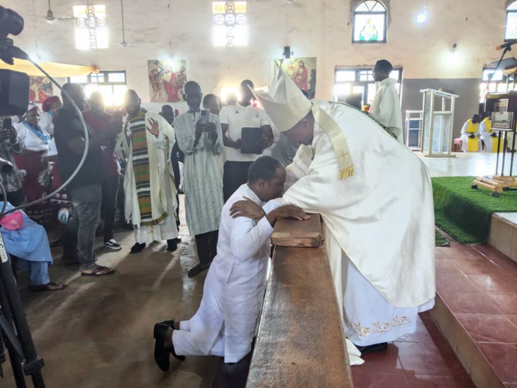 Muri Ajaka being blessed by the Catholic Bishop
