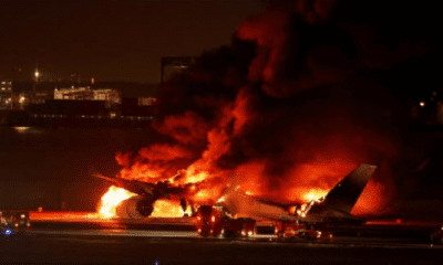 Plane with nearly 400 people on board bursts into flames after collision