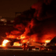 Plane with nearly 400 people on board bursts into flames after collision