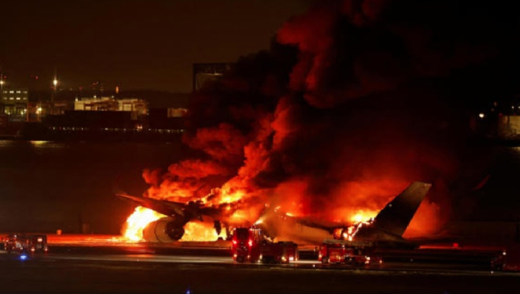 Plane with nearly 400 people on board bursts into flames after collision